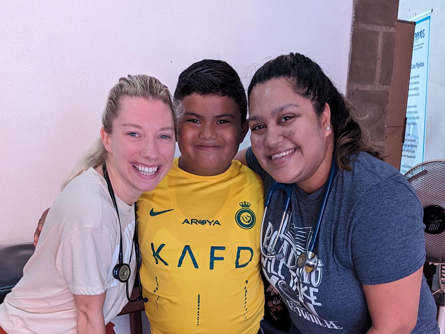 FNE clinicians with a young patient during a community health visit