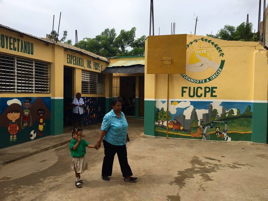 FUCPE school building with colorful murals and the school logo