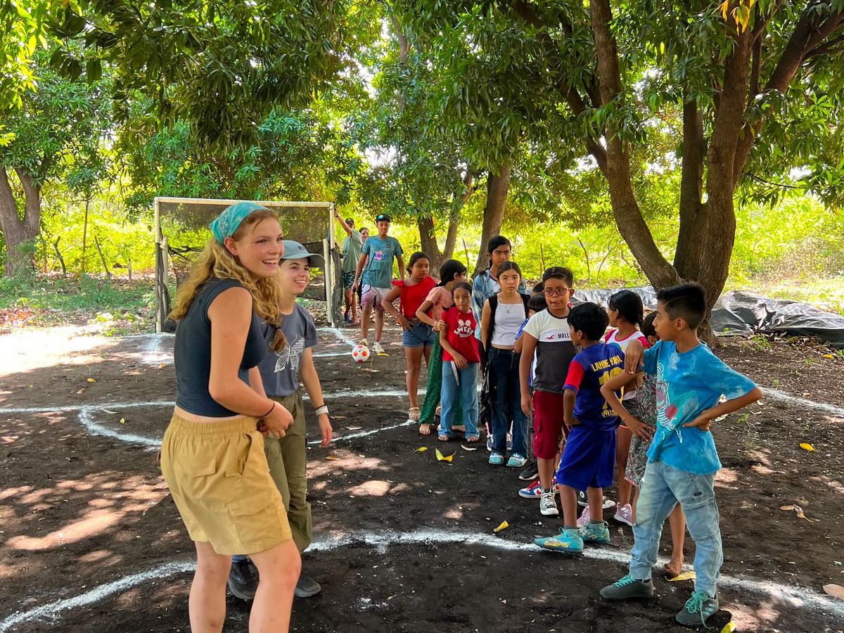 Local children taking part in an activity with an FNE volunteer