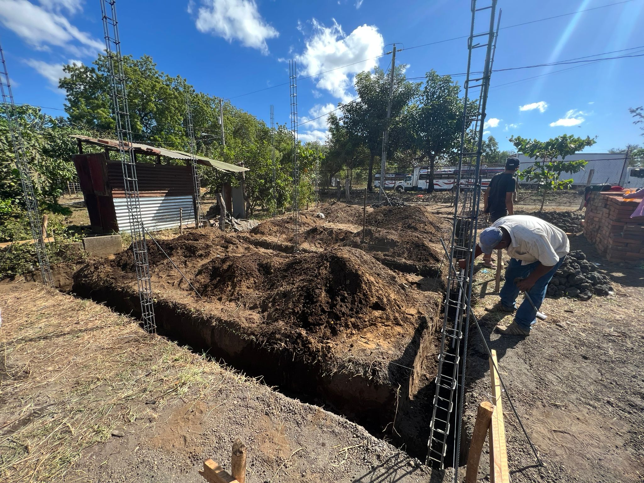Volunteers and family members laying foundation