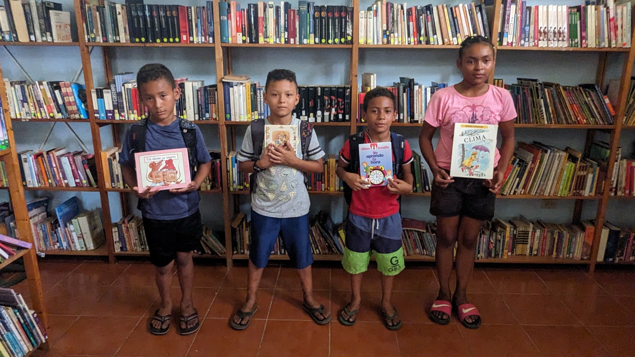Children holding books at the community library in Nicaragua
