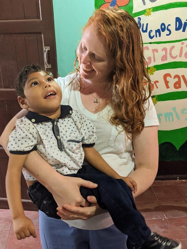 Dr. Brittany holding a young SPTLN patient in Nicaragua