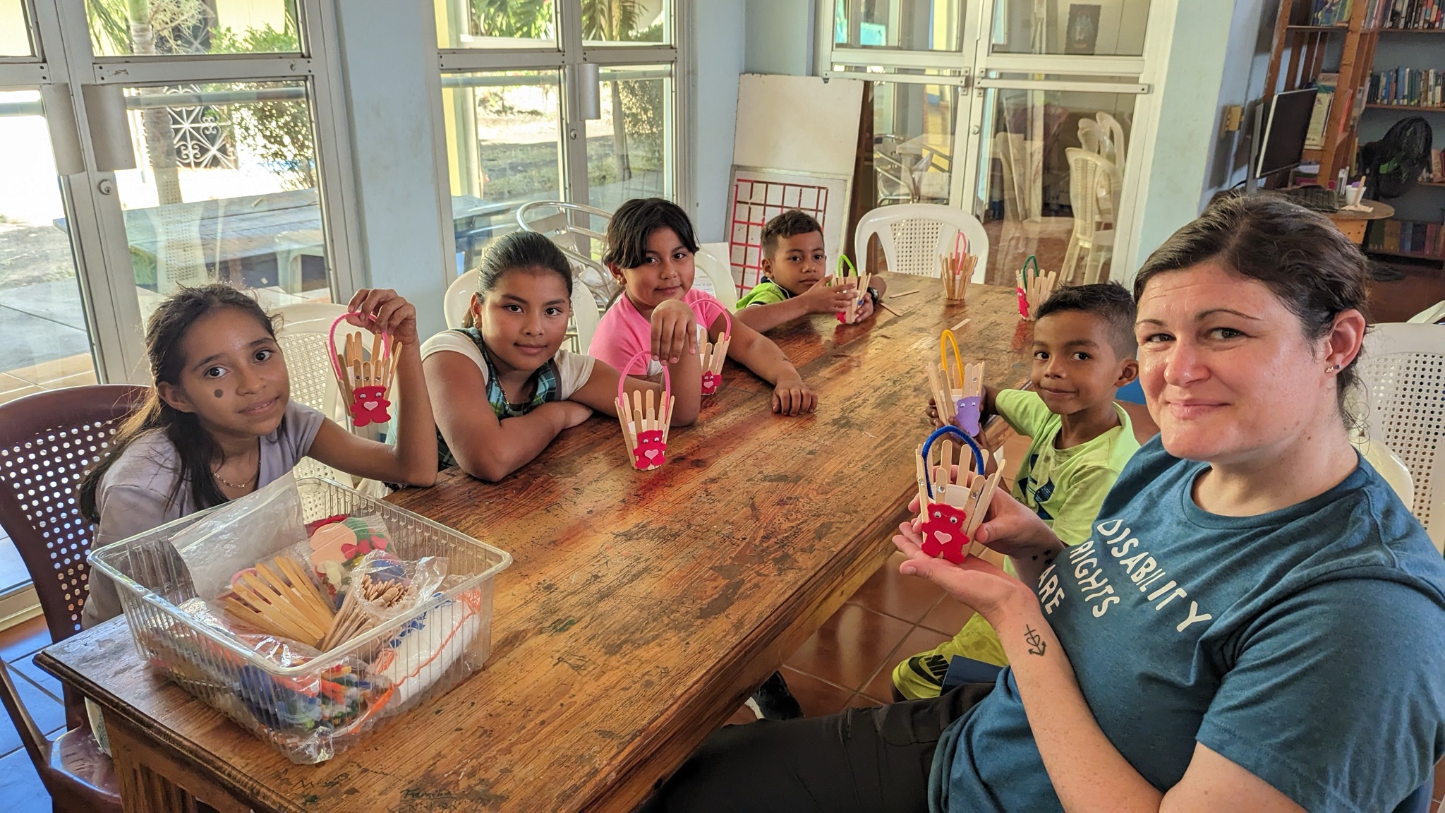 Volunteer with children doing crafts